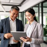 two happy asian business people meeting at the office